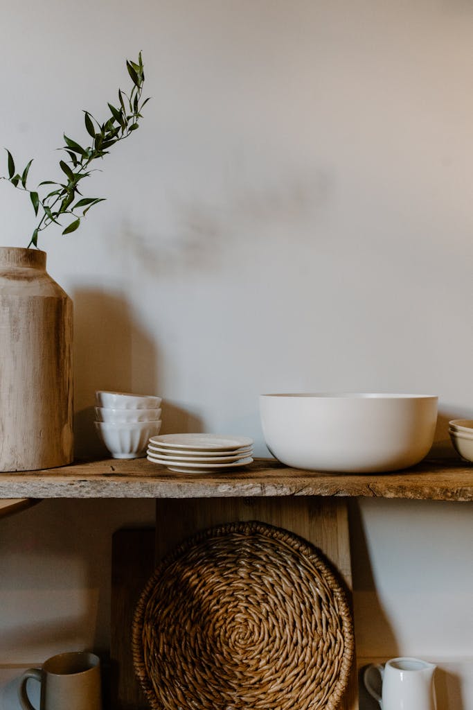 A stylish minimalist kitchen shelf with rustic elements and elegant tableware.