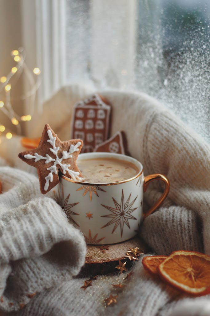 Cozy winter setting featuring hot chocolate with star-shaped gingerbread and festive decorations.