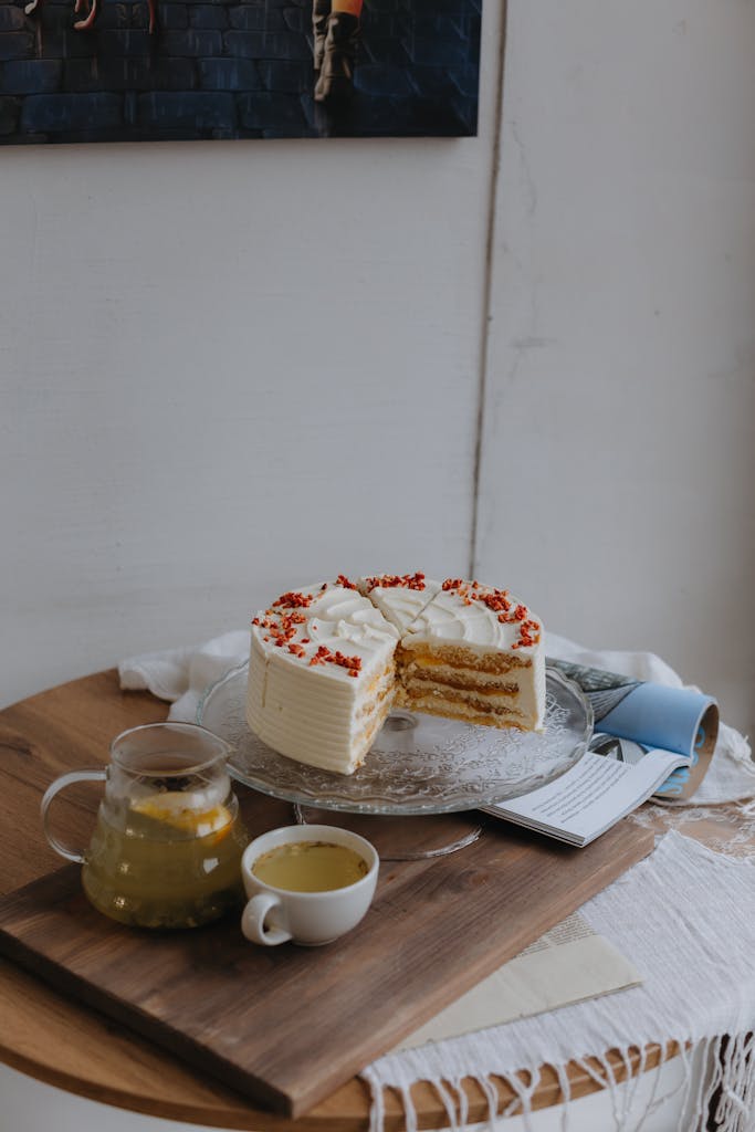 Inviting dessert scene with layered cake and fruit tea on a wooden table.